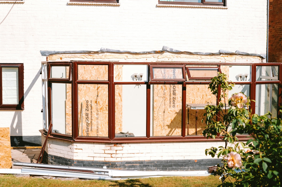 Conservatory under construction with boarded up windows